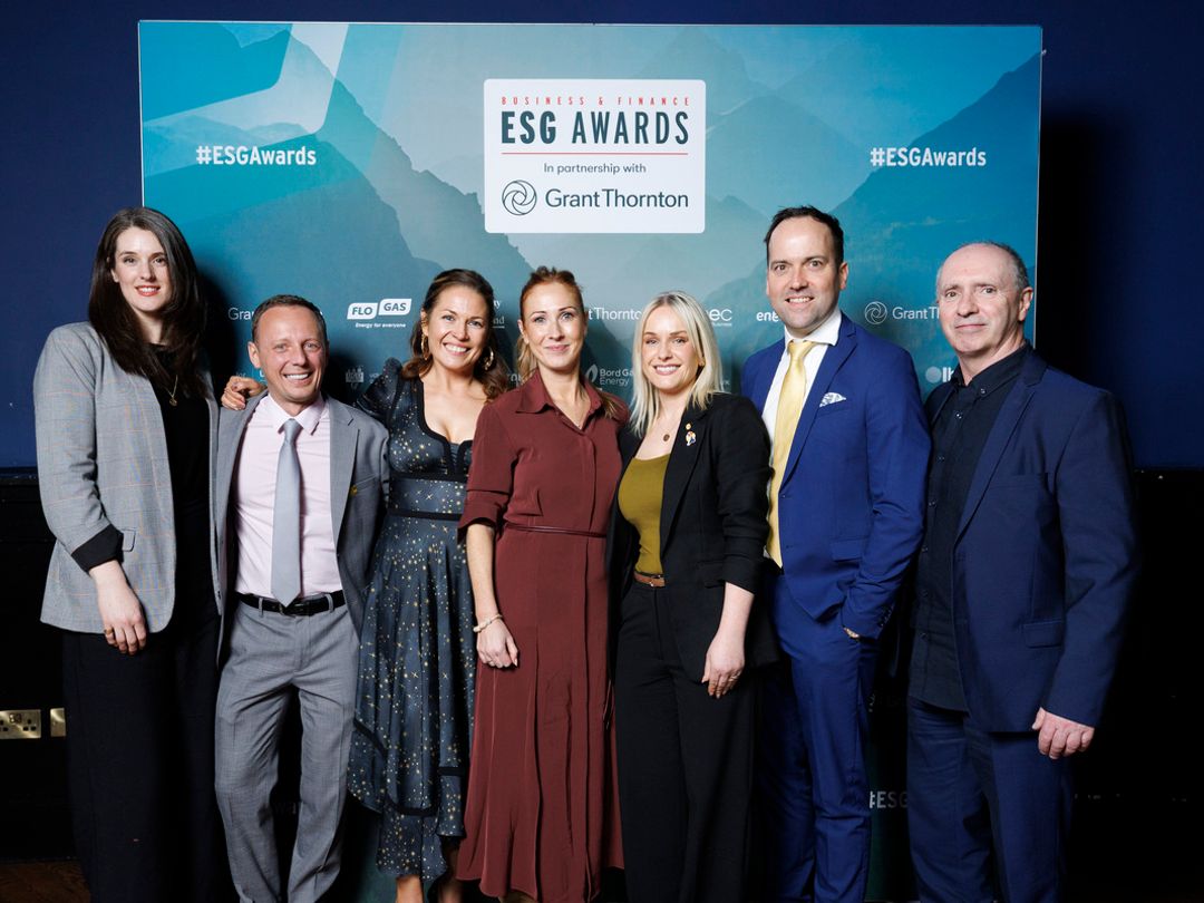 Seven people, three men and four women stand in front of ESG Award banner