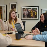 Four Dogs Trust members of staff having a meeting in an office