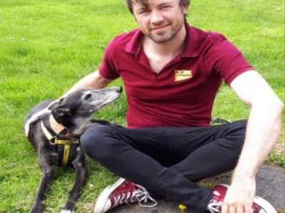 Paul Cleary sitting outside with a Greyhound