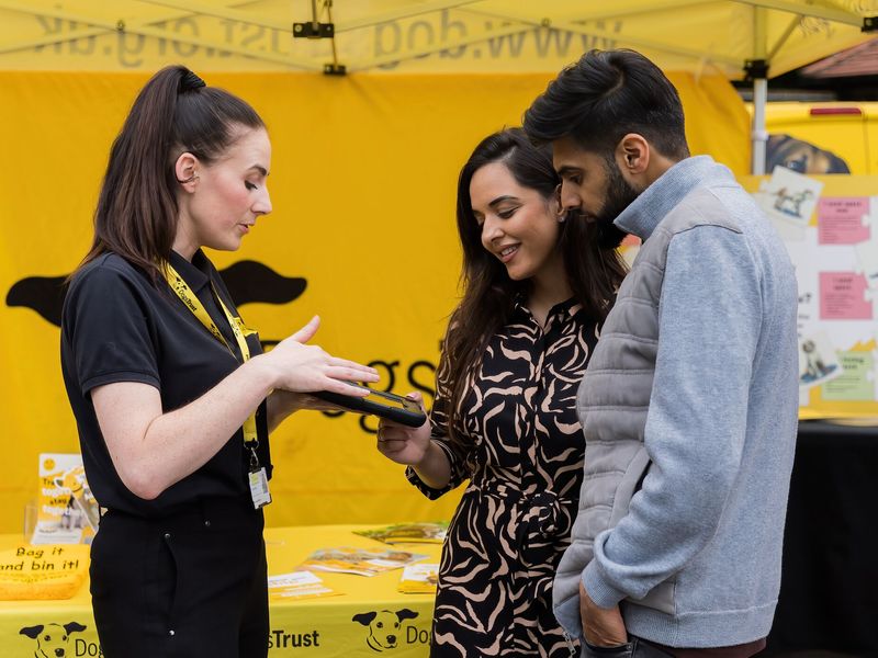 Family engaging with Dogs Trust staff at a community event