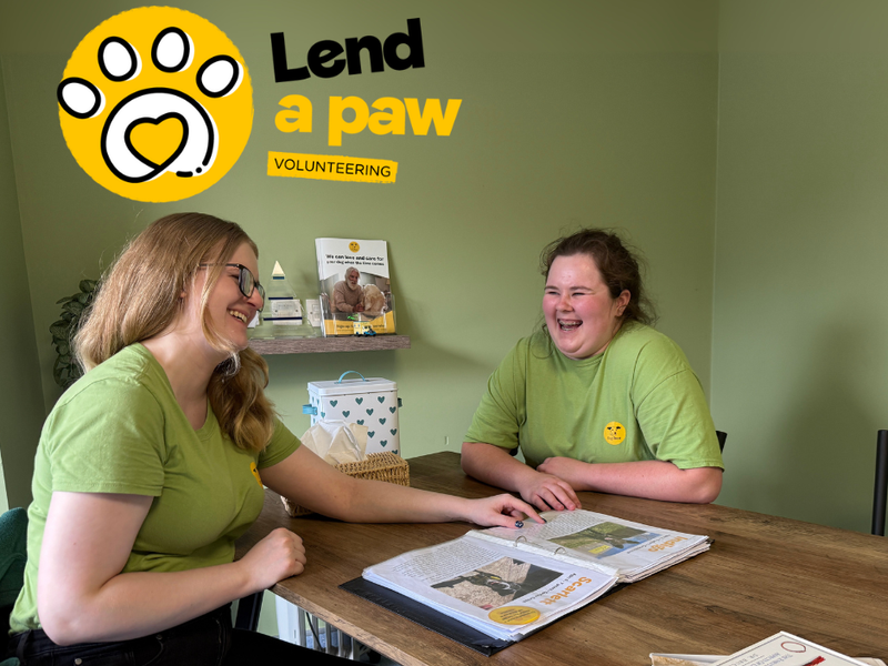 Volunteers laughing w/lend a paw logo